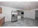 Bright kitchen offers stainless steel refrigerator and breakfast bar leading into the dining area at 2922 W Citrus Way, Phoenix, AZ 85017