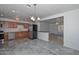 An open-concept kitchen and dining area, with stainless appliances, cabinetry, and tiled floors at 2922 W Citrus Way, Phoenix, AZ 85017