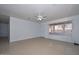 An open-concept living room with tile flooring, neutral paint, and a ceiling fan at 2922 W Citrus Way, Phoenix, AZ 85017