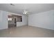 Bright living room featuring tile floors, a ceiling fan, and an open layout to the kitchen at 2922 W Citrus Way, Phoenix, AZ 85017