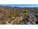 Scenic aerial view showcasing the desert landscape, community homes, and the lush green golf course at 3030 N Saranac --, Mesa, AZ 85207