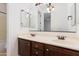 Bathroom with dual sinks, dark cabinetry, and a large mirror, accented by stylish lighting fixtures at 3030 N Saranac --, Mesa, AZ 85207