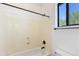 Bathtub and shower combo features a built-in soap dish, window, and standard fixtures at 3030 N Saranac --, Mesa, AZ 85207
