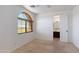 Bedroom with an arched window, neutral carpeting, and an open doorway to the en-suite bathroom at 3030 N Saranac --, Mesa, AZ 85207