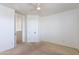 Minimal bedroom with a ceiling fan, neutral carpet and paint, with doorway leading to the hallway at 3030 N Saranac --, Mesa, AZ 85207
