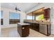 A stylish kitchen with an island, stainless steel appliances, and lots of natural light from the large window at 3030 N Saranac --, Mesa, AZ 85207