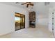 An open living area with a stone fireplace and sliding glass doors to a balcony, perfect for indoor-outdoor living at 3030 N Saranac --, Mesa, AZ 85207