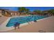A large swimming pool with lap lanes and lounge area with seating at a community clubhouse on a sunny day at 3030 N Saranac --, Mesa, AZ 85207