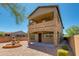 Two-story rear exterior showcasing stone accents, covered patio, and outdoor space featuring a tranquil water fountain at 3030 N Saranac --, Mesa, AZ 85207