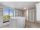 Large walk-in closet with custom shelving, drawers, and a center island for organized storage at 3030 N Saranac --, Mesa, AZ 85207