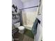 Well lit full bathroom with decorative shower curtain, toilet, and shelves at 30394 N Appalachian Trl, San Tan Valley, AZ 85143