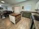 Open concept kitchen includes an island with wicker basket storage, stainless appliances, and ample counter space at 30394 N Appalachian Trl, San Tan Valley, AZ 85143