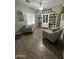 Cozy seating area with wood-look tile flooring and a built-in bookshelf creates a relaxing atmosphere at 30394 N Appalachian Trl, San Tan Valley, AZ 85143