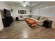 Inviting living room features cozy sectional sofa, tile floors, and stylish decor at 30394 N Appalachian Trl, San Tan Valley, AZ 85143