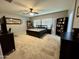 Spacious bedroom featuring carpet floors, ceiling fan, and two dark wood bookshelves at 30394 N Appalachian Trl, San Tan Valley, AZ 85143