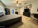 Bright bedroom featuring carpet floors, a ceiling fan, and dark wood furniture at 30394 N Appalachian Trl, San Tan Valley, AZ 85143