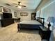 Bright bedroom featuring carpet floors, a ceiling fan, and dark wood furniture at 30394 N Appalachian Trl, San Tan Valley, AZ 85143