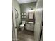 Charming powder room featuring decorative mirror, stylish vanity, and soothing green walls at 30394 N Appalachian Trl, San Tan Valley, AZ 85143