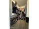 Organized walk-in closet with built-in shelves, hanging rods, and shoe racks at 30394 N Appalachian Trl, San Tan Valley, AZ 85143