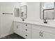 Elegant bathroom featuring dual sinks, modern black fixtures, and sleek white cabinetry at 3105 W Romana Dr, Eloy, AZ 85131
