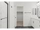 Modern bathroom with a black framed shower and closet with matte black hardware and dark tile floors at 3105 W Romana Dr, Eloy, AZ 85131