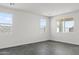 Spacious bedroom showcasing tile floors and white walls, illuminated by natural light through three windows at 3105 W Romana Dr, Eloy, AZ 85131