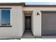 Close-up view of the home's entry, showcasing a modern dark-stained front door and attached garage at 3105 W Romana Dr, Eloy, AZ 85131