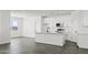 Modern kitchen featuring white cabinetry, stainless steel appliances, and sleek countertops, open to the living area at 3105 W Romana Dr, Eloy, AZ 85131