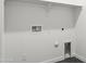 A laundry room that has connections for a washer and dryer, electrical outlets and a shelf at 3105 W Romana Dr, Eloy, AZ 85131