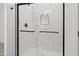 Modern frameless shower with white marble tile, black hardware, and built-in shelving at 3105 W Romana Dr, Eloy, AZ 85131