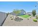 Landscaped backyard featuring a small patch of green lawn, desert landscaping and a pergola-covered patio at 3310 E Valleyhigh Trl, San Tan Valley, AZ 85143