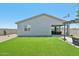 Spacious backyard with lush artificial turf, patio area, perfect for outdoor gatherings at 3310 E Valleyhigh Trl, San Tan Valley, AZ 85143