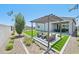 Inviting backyard patio with modern seating, complemented by a pergola, desert landscaping, and artificial turf at 3310 E Valleyhigh Trl, San Tan Valley, AZ 85143