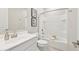 Clean bathroom with white tiling, framed prints, a shower-tub combo, and modern fixtures at 3310 E Valleyhigh Trl, San Tan Valley, AZ 85143