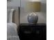 Close up of a lamp on a nightstand next to a neatly made bed in a serene bedroom setting at 3310 E Valleyhigh Trl, San Tan Valley, AZ 85143