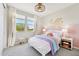 Bright bedroom featuring a decorative wall, fan, and natural light from the windows at 3310 E Valleyhigh Trl, San Tan Valley, AZ 85143