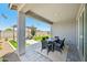 A covered outdoor patio has a dining table, and views of a pergola, artificial turf, and desert landscaping at 3310 E Valleyhigh Trl, San Tan Valley, AZ 85143