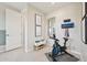 Modern exercise room including workout equipment and a bench and a view through a window at 3310 E Valleyhigh Trl, San Tan Valley, AZ 85143
