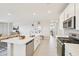 Open kitchen view showcases stainless steel appliances, white cabinets, and quartz countertops at 3310 E Valleyhigh Trl, San Tan Valley, AZ 85143
