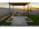 Outdoor patio area with comfortable seating under a pergola, ideal for relaxing and entertaining at 3310 E Valleyhigh Trl, San Tan Valley, AZ 85143