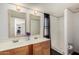 Bathroom featuring double sinks, decorative mirrors and a walk-in shower with a black curtain at 48773 Cerezo Rd # 20, Maricopa, AZ 85139