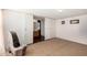 Bedroom with carpet floor featuring a bathroom view through sliding doors at 48773 Cerezo Rd # 20, Maricopa, AZ 85139