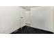 Simple bedroom with neutral walls and dark carpet, leads to another room at 48773 Cerezo Rd # 20, Maricopa, AZ 85139