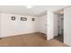 Neutral-toned bedroom featuring a carpet floor with large closet and a hallway entrance at 48773 Cerezo Rd # 20, Maricopa, AZ 85139