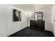 Bonus room with carpet floor, a dresser, a painting and a big window at 48773 Cerezo Rd # 20, Maricopa, AZ 85139