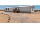 Charming mobile home with a quaint porch and neutral color palette, perfect for simple living at 48773 Cerezo Rd # 20, Maricopa, AZ 85139