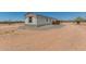 View of the mobile home exterior on a large lot with gravel and dirt ground at 48773 Cerezo Rd # 20, Maricopa, AZ 85139