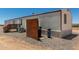 Side view of mobile home on a gravel lot with brown trim and small porch at 48773 Cerezo Rd # 20, Maricopa, AZ 85139