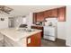 Functional kitchen featuring an island with a sink and ample cabinet space, adjacent to the living area at 48773 Cerezo Rd # 20, Maricopa, AZ 85139