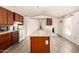 Bright kitchen features wood cabinets and island countertop with sink; open floorplan at 48773 Cerezo Rd # 20, Maricopa, AZ 85139